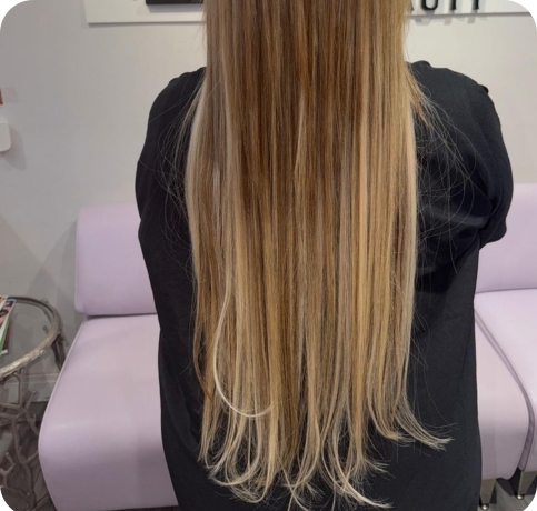Long blonde hair extensions at Karmi Beauty Salon in Jamaica Queens